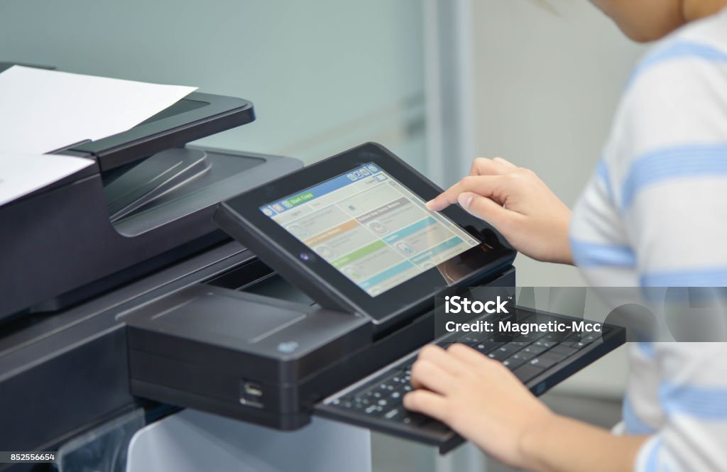 Business woman is using the printer to scanning and printing document Printer - Occupation Stock Photo