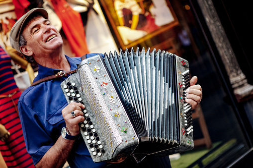 Istanbul, Turkey - May 26, 2015: A Romanian street musician playing accordion in the Istiklal street.