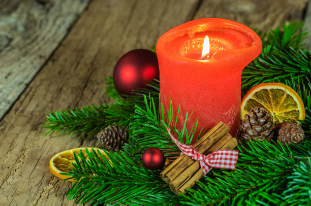 istock Christmas decoration with red burning candle 852565956