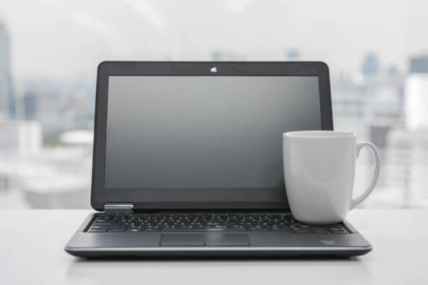 istock White coffee cup is on the black laptop - Time to break 852570878