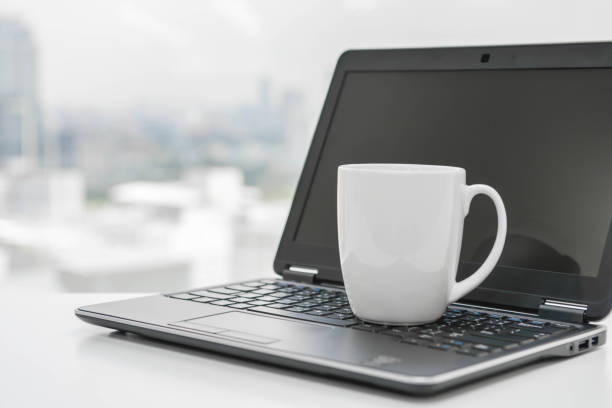 istock White coffee cup is on the black laptop - Time to break 852570968