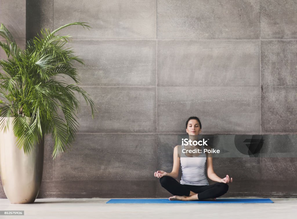 young woman practicing yoga. Meditation and harmony concept Young girl meditating in yoga class Yoga Stock Photo