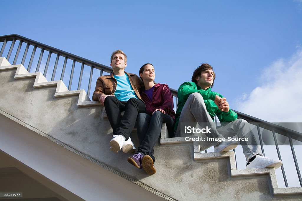 Friends sitting on stairway  30-39 Years Stock Photo