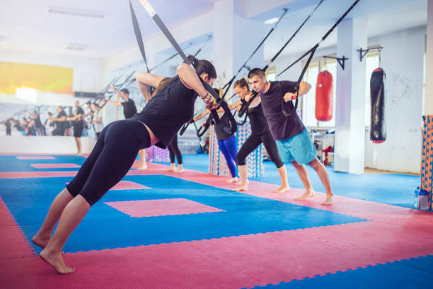 istock People doing arm exercises with suspension straps 852589320