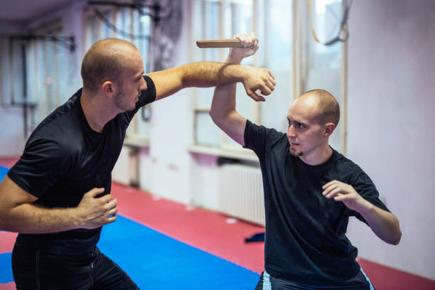 Self - defence Men training in the gym. They are doing self - defence exercise weight class stock pictures, royalty-free photos & images