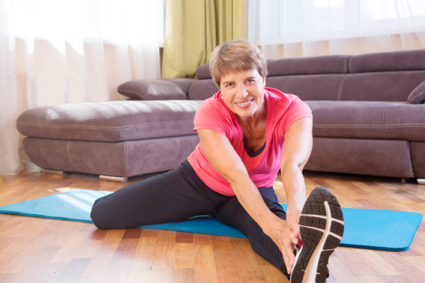 istock Cheerful senior lady exercising in the home 852605094