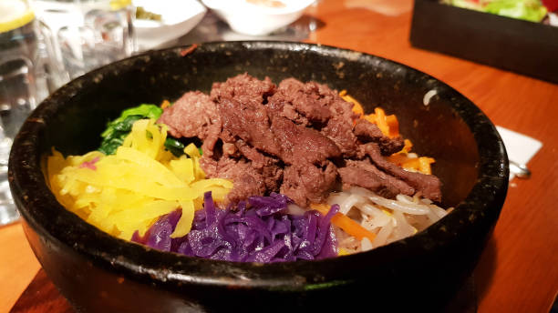 istock Korean food - beef Bibimbap in a hot stone bowl 852608044