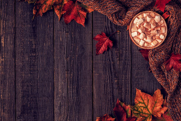 istock Autumn background with hot chocolate, knitted scarf, multi-colored leaves. 852612054
