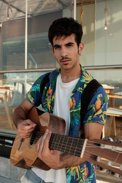 istock Young man playing guitar close to restaurant 852617668