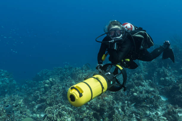 Diver girl on scooter in the coral reef in the Caribbean Sea around Curacao stock photo