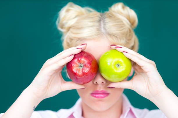 istock Blond woman with Apple in Hand 852621308