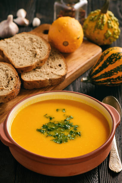istock Homemade pumpkin cream soup on black background. 852634916