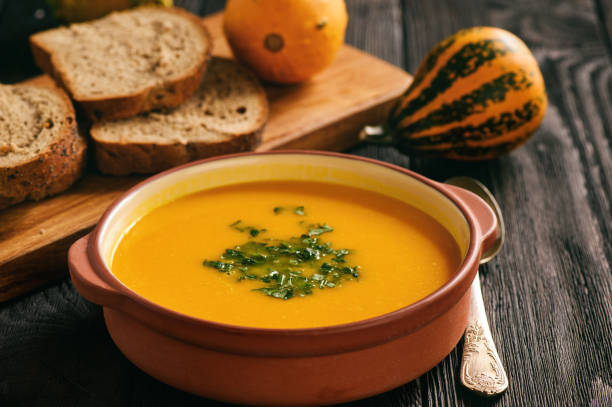 istock Homemade pumpkin cream soup on black background. 852634978