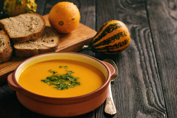 istock Homemade pumpkin cream soup on black background. 852634980