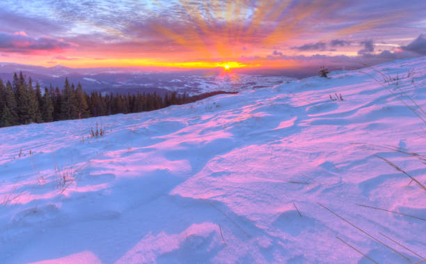 istock Amazing colorful sunrise in mountains with colored clouds and pink snow on foreground. . Dramatic wintry scene with snow 852641272