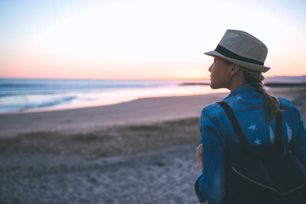 istock Young woman with backpack on the beach 852641744
