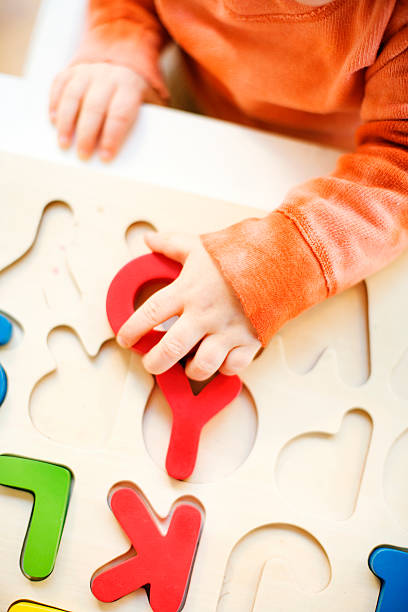 toddler boy playing with alphabet puzzle - one baby boy only zdjęcia i obrazy z banku zdjęć