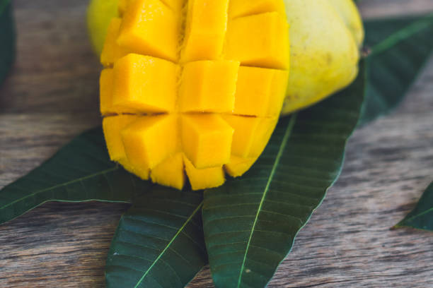 istock Mango and mango leaves on an old wooden background 852647444
