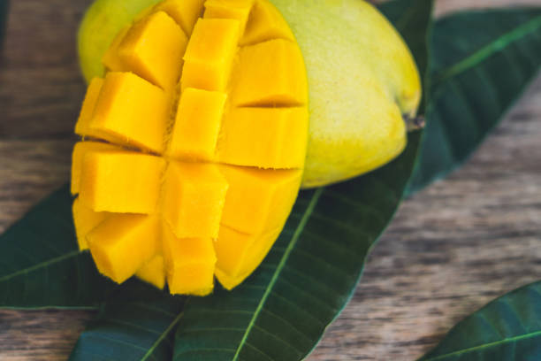istock Mango and mango leaves on an old wooden background 852649816