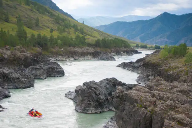 small rafting in rapid mountain river among rocks