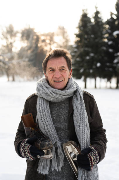istock Senior man in sunny winter nature going ice skating. 852674358