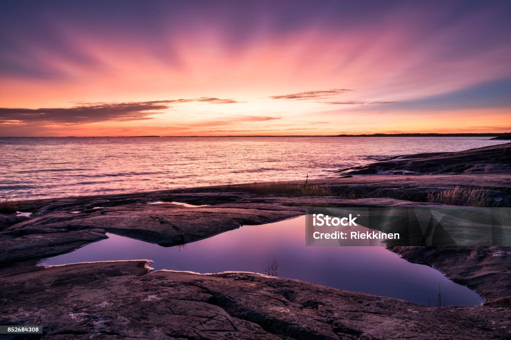 Epic sunset with beautiful color and sea at autumn evening in Porkkalanniemi, Finland Purple Stock Photo