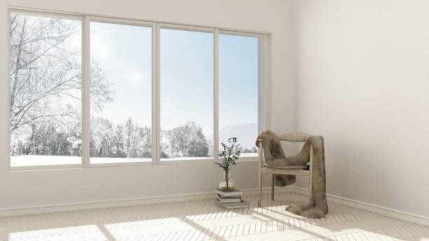 Empty room with wooden chair with fur couch and large window with panoramic view, winter mountains, snow, interior design