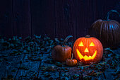 Smiling Jack O' Lantern on old wooden porch in the moon light