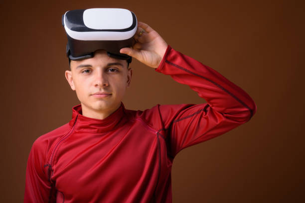 istock Studio shot of young handsome man using virtual reality headset against colored background 852701574