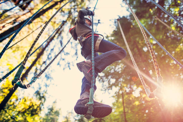istock Little girl walking on ropes course 852701600