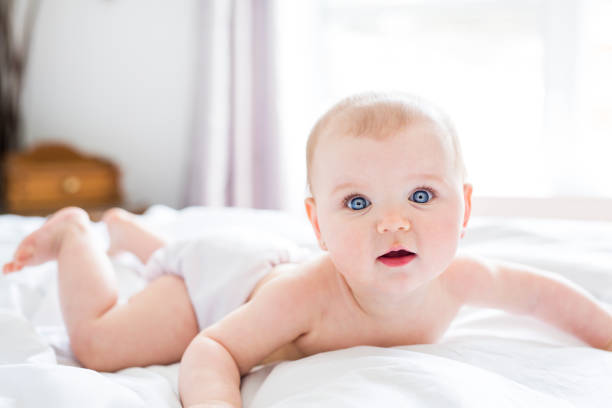 istock Baby girl in white bedding at home look nice 852729476