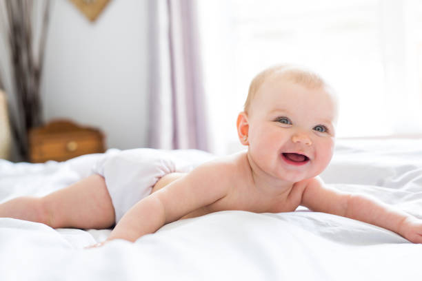istock Baby girl in white bedding at home look nice 852729530