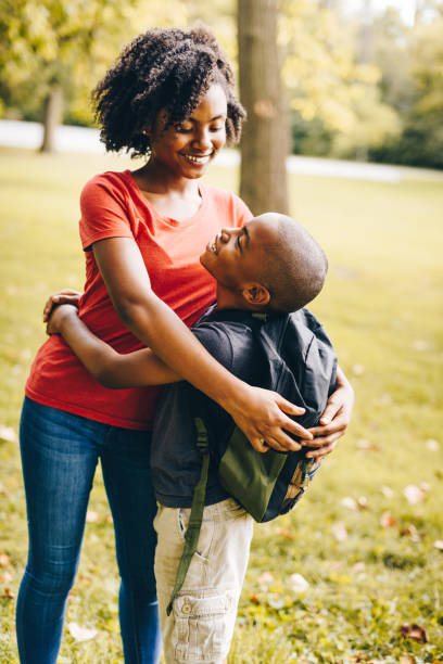 istock brother and sister embracing at the park 852732166
