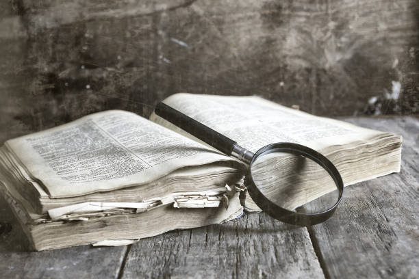 istock old scratched effect on photo magnifying glass and old book 852738450