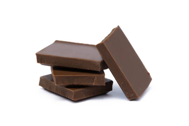 istock Milk chocolate pieces isolated on white background 852742920