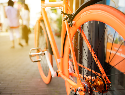 Orange bike parked in city Amsterdam