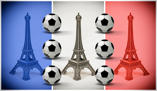 Multicolored Eiffel Tower models with french flag and soccer balls. Concept for football championship