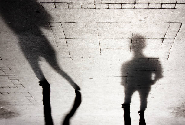 shadow silhouette of two people - shadow focus on shadow people men imagens e fotografias de stock