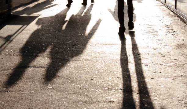 istock Blurry shadows and silhouettes on city sidewalk 852765804