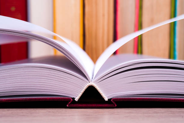 istock Open book, hardback books on bright colorful background. 852779976