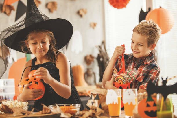 istock Children carrying their Halloween catch 852780690
