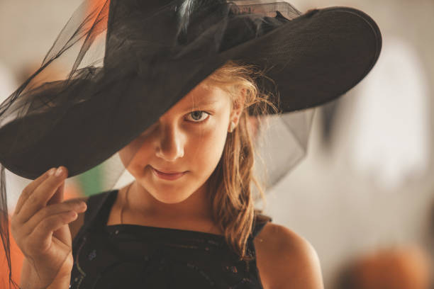 Beautiful girl dressed up as a witch on a Halloween party. She is celebrating her favorite holiday.