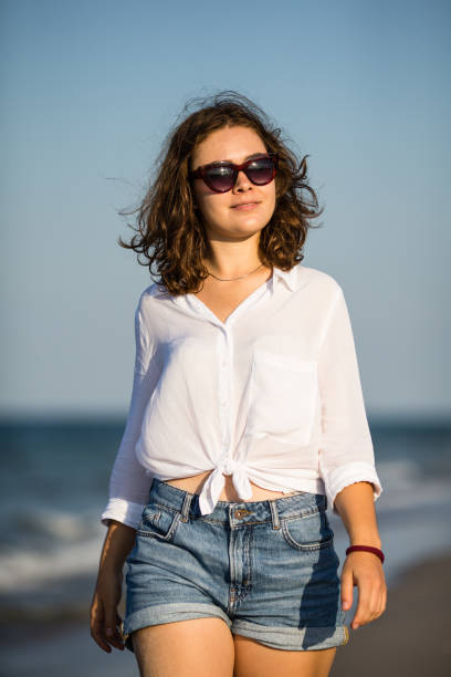 istock Young women walking on beach 852797428