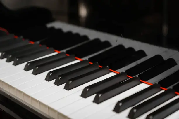 Piano keys on black classical grand piano for classic music