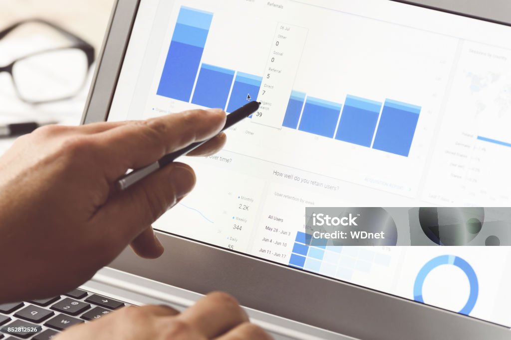 Modern digital marketing Businessman using internet analytics in the office on the touch screen of his laptop (reduced tone) Search Engine Stock Photo