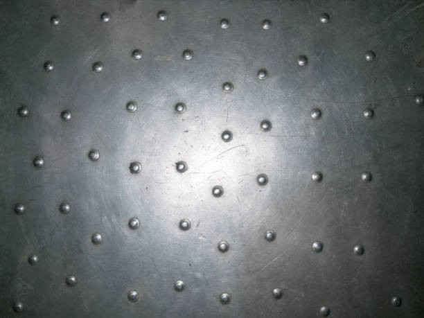 istock Shiny scratched metal surface rivets close up 852816686