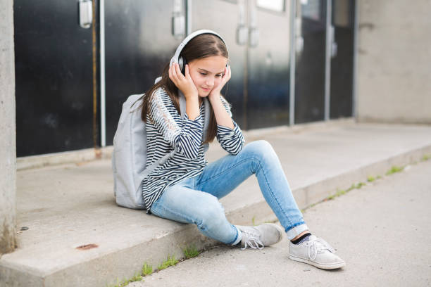 Elementary school pupil outside carrying rucksack