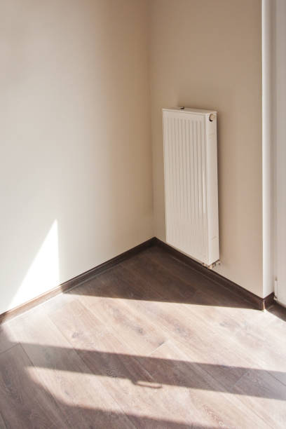 istock The microclimate in the house, sunlight through a large window on the wall, a white radiator on the wall 852831070