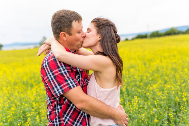 istock Happy smiling young couple over yellow green rape meadow 852844692