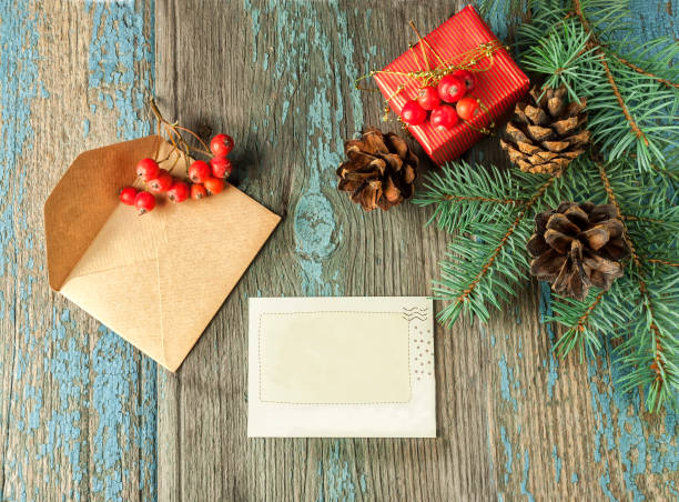 istock Christmas card: empty paper form with fir-tree branches on old wooden background, copyspace 852853438